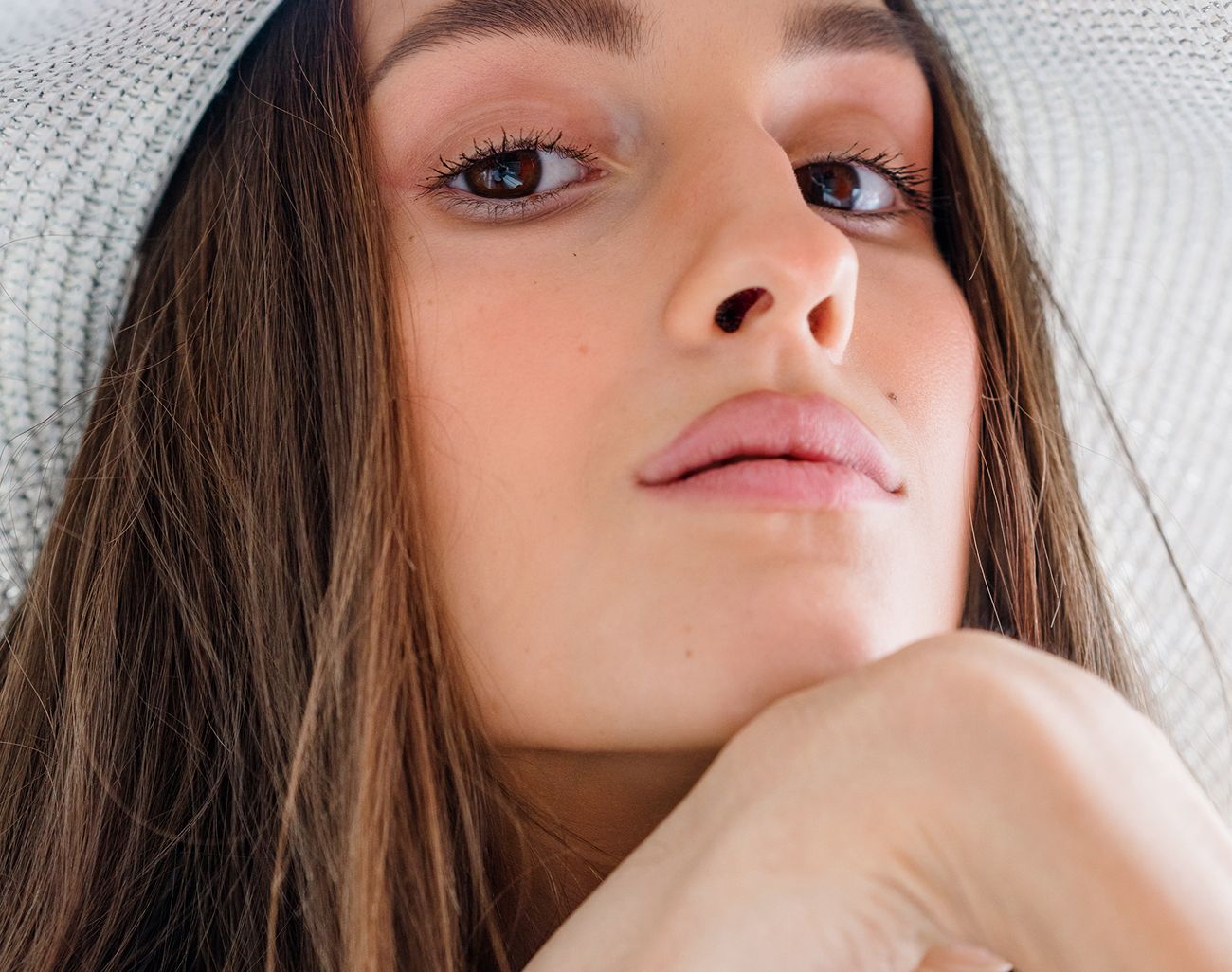 Woman with long hair wearing a large hat.